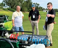Photo of LM Growth Summit partners and attendee discussing a product