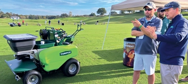 Photo of Growth Summit attendee and partner discussing a new product