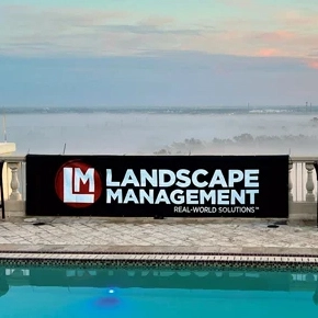 Photo of Landscape Management banner by the pool during the LM Growth Summit